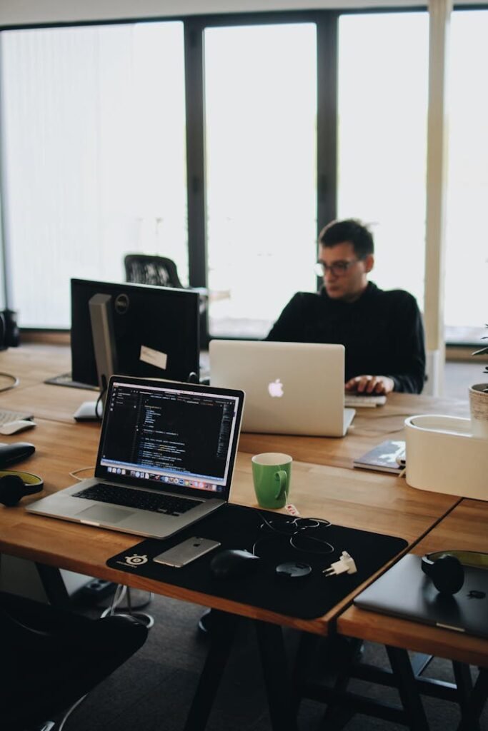 Mastering the First Impression: Your intriguing post title goes here A web developer working on code in a modern office setting with multiple devices.
